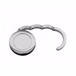 Porta bolsa de metal dobrável cromado.